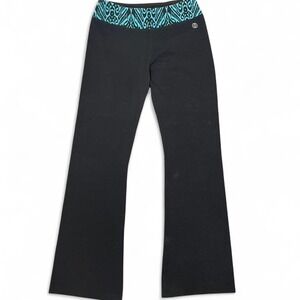 Black Balance Collection flare leg yoga pants with blue and black print waistban